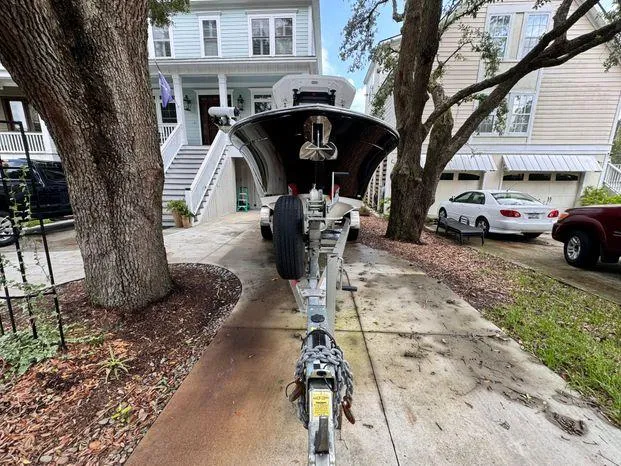 Slide: The Image of 2021 Blackfin 252 CC boat on trailer in residential driveway. - 8