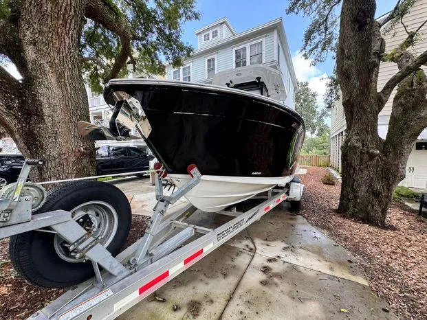 Slide: The Image of 2021 Blackfin 252 CC boat on trailer, parked in residential driveway. - 9
