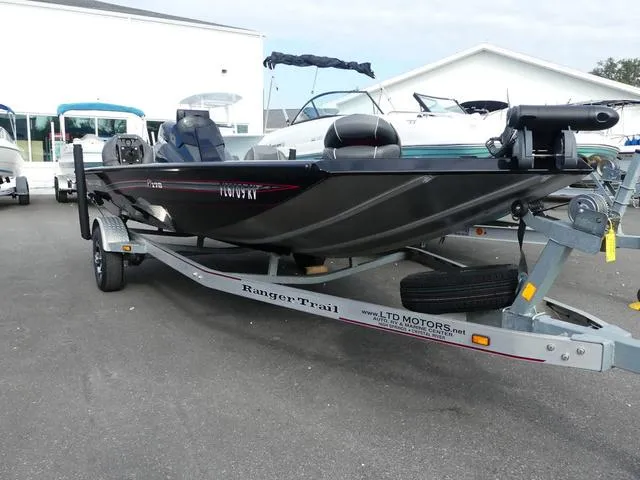 Slide: The Image of 2018 Ranger RT178 boat speeding on a lake with two passengers. - 1
