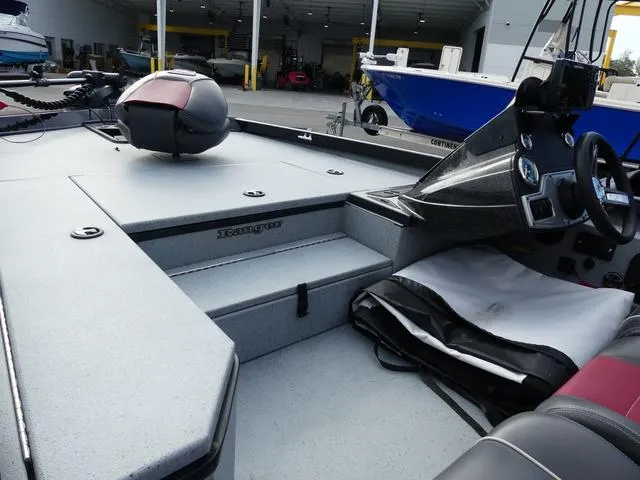 Slide: The Image of 2018 Ranger RT178 boat interior with steering console and seating in a showroom. - 17