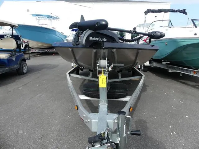 Slide: The Image of 2018 Ranger RT178 boat on trailer with MotorGuide motor in a marina. - 2