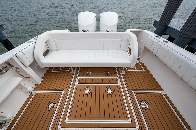 Slide: The Image of 2014 Intrepid 327 Center Console boat with teak deck and white seating. - 13