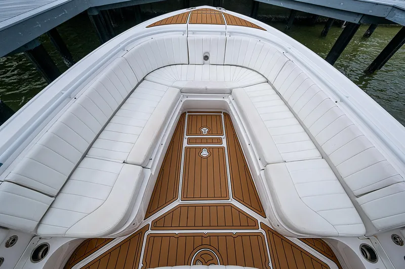 Slide: The Image of 2014 Intrepid 327 Center Console with white seating and teak flooring. - 18