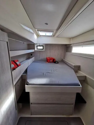 Slide: The Image of Leopard 48 yacht interior cabin with bed, storage, and life jackets, 2017 model. - 14