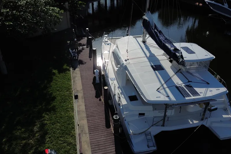 Slide: The Image of Aerial view of 2017 Leopard 48 catamaran docked by a wooden pier. - 2
