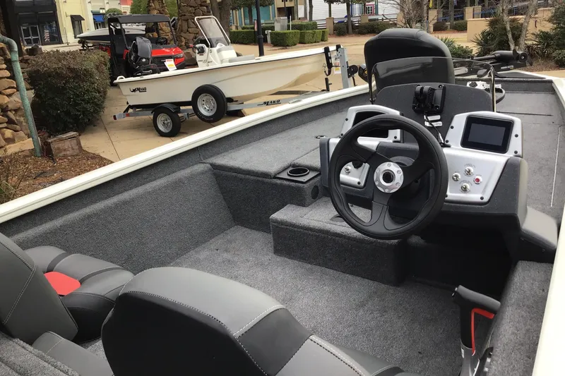 Slide: The Image of 2025 Tracker Pro Team 175 boat interior with steering wheel and dashboard controls. - 2