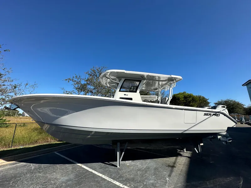 The Image of 2025 Sea Pro 322 Offshore boat in a parking lot under clear blue sky. - 1
