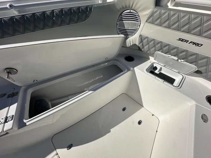 Slide: The Image of 2025 Sea Pro 322 Offshore boat interior with storage compartments and sleek design. - 13