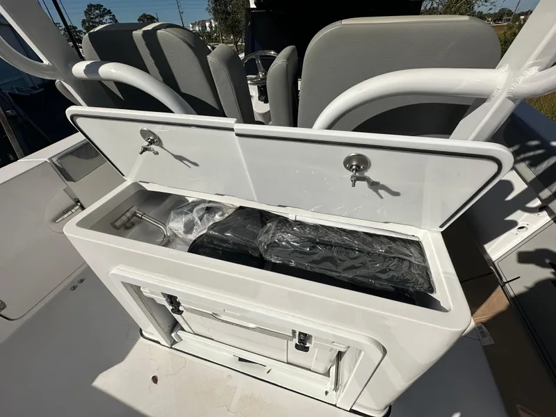 Slide: The Image of 2025 Sea Pro 322 Offshore boat storage compartment with seating in background. - 20