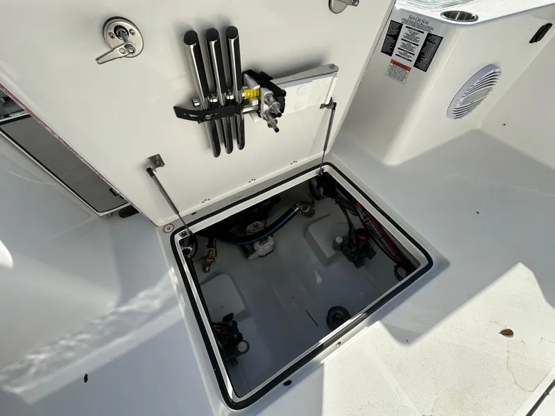 Slide: The Image of 2025 Sea Pro 322 Offshore boat storage compartment with open hatch and equipment. - 24