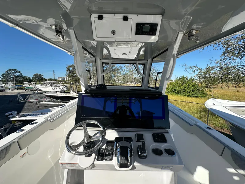 Slide: The Image of 2025 Sea Pro 322 Offshore boat cockpit with modern controls and steering wheel. - 5