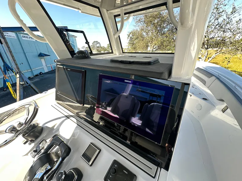 Slide: The Image of 2025 Sea Pro 322 Offshore boat dashboard with modern navigation equipment. - 7