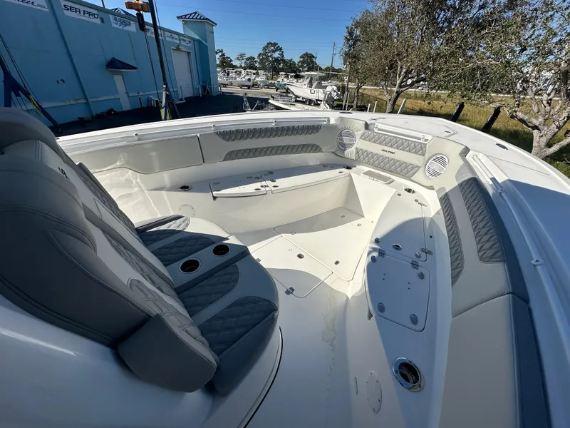 Slide: The Image of 2025 Sea Pro 322 Offshore boat interior with seating and storage compartments. - 9