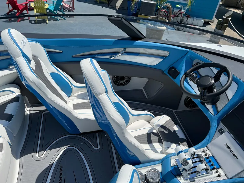 Slide: The Image of Luxurious MTI 390X 2022 boat interior with blue and white seating and modern dashboard. - 11