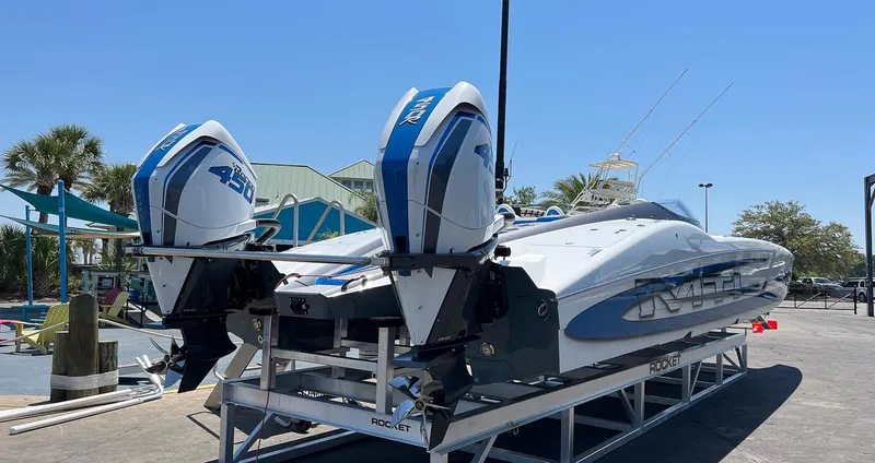 Slide: The Image of 2022 MTI 390X boat with dual outboard engines on a trailer. - 14