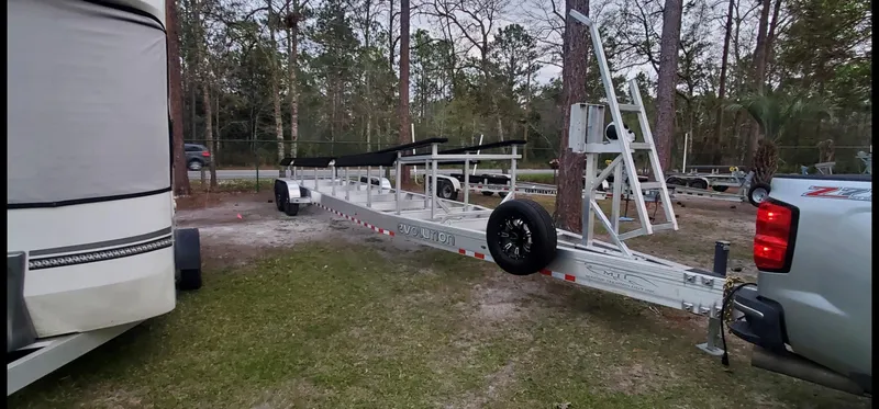 Slide: The Image of 2022 MTI 390X trailer parked outdoors near trees and vehicles. - 18