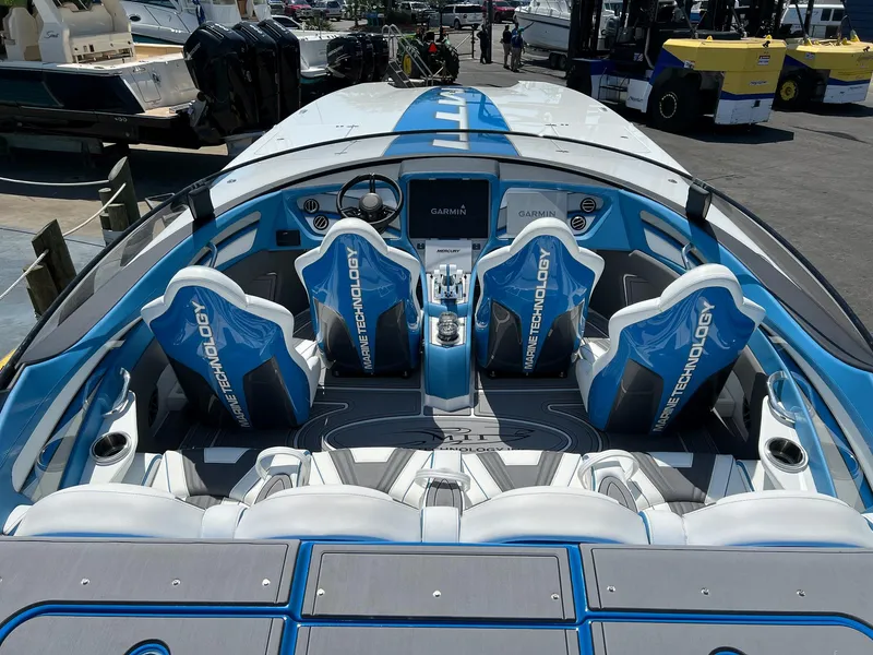 Slide: The Image of 2022 MTI 390X boat interior with blue and white seats, advanced dashboard technology. - 7