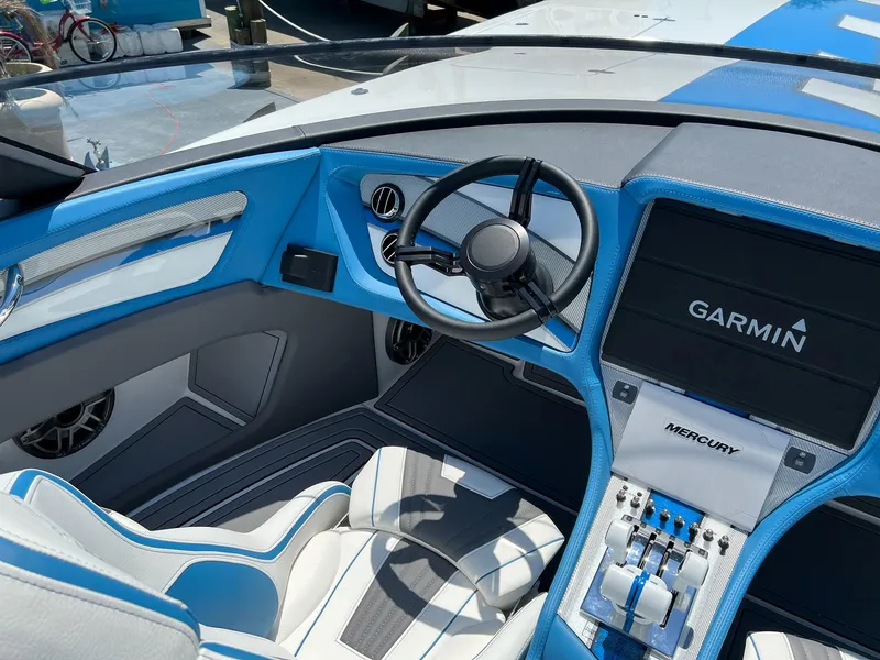 Slide: The Image of 2022 MTI 390X boat cockpit with Garmin navigation and Mercury controls, featuring blue and white interior. - 9