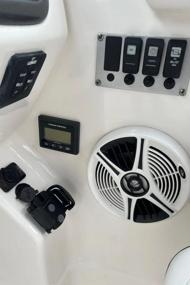 Slide: The Image of 2011 Chaparral Sunesta 244 Xtreme boat dashboard with controls and speaker. - 10