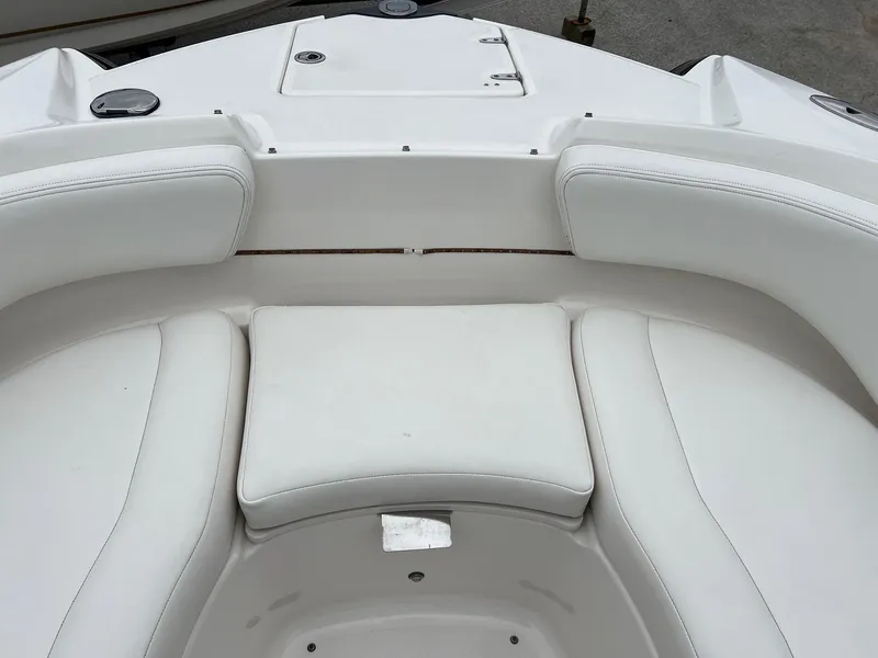 Slide: The Image of 2011 Chaparral Sunesta 244 Xtreme boat interior with white cushioned seating. - 13