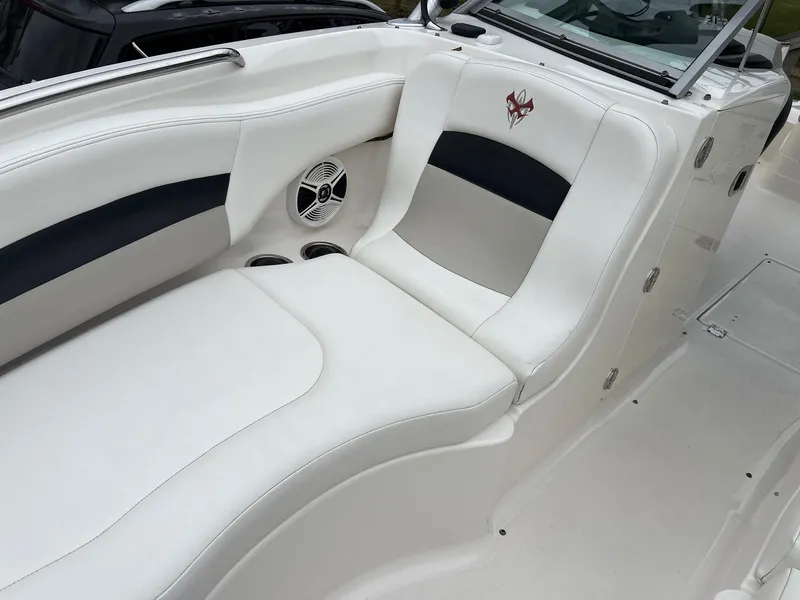 Slide: The Image of 2011 Chaparral Sunesta 244 Xtreme boat interior with white seating and speaker. - 15