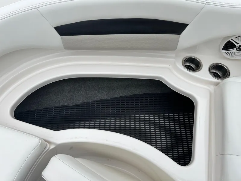 Slide: The Image of 2011 Chaparral Sunesta 244 Xtreme boat interior with cup holders and speaker. - 17