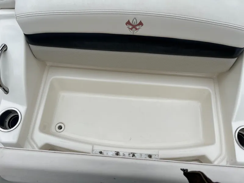 Slide: The Image of 2011 Chaparral Sunesta 244 Xtreme boat seating area with storage compartment and cup holders. - 19