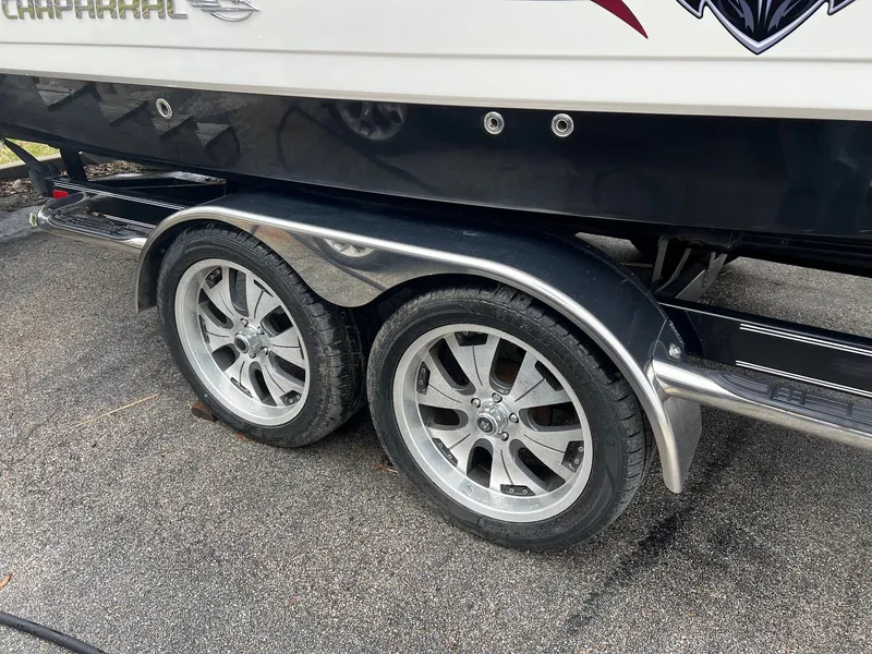 Slide: The Image of 2011 Chaparral Sunesta 244 Xtreme trailer with dual wheels on pavement. - 20