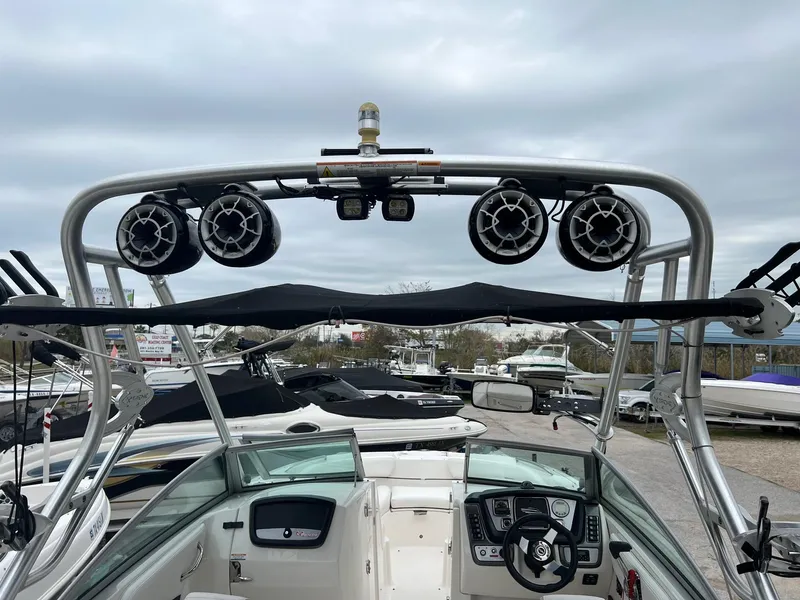 Slide: The Image of 2011 Chaparral Sunesta 244 Xtreme boat with wakeboard tower and speakers. - 4