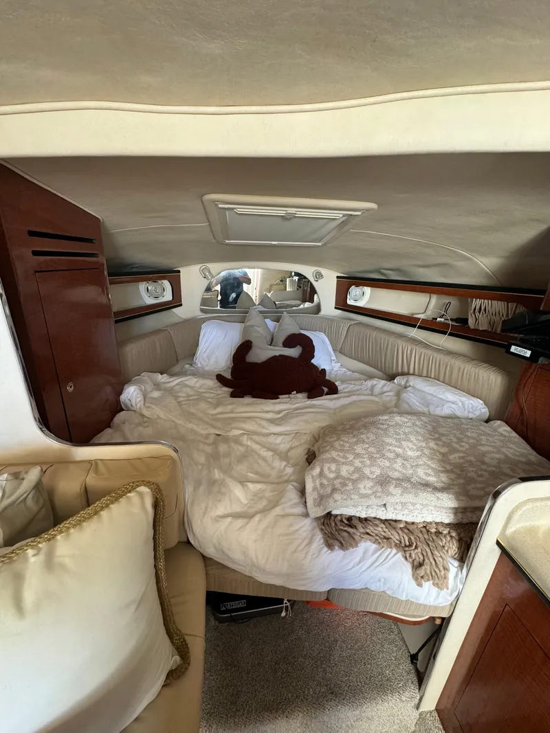 Slide: The Image of Cozy cabin interior of 2002 Sea Ray Sundancer with plush bedding and wooden accents. - 11