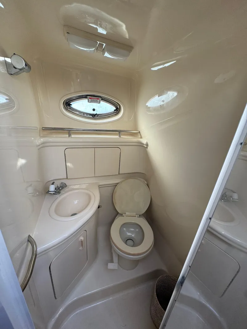 Slide: The Image of 2002 Sea Ray Sundancer bathroom interior with sink and toilet. - 13