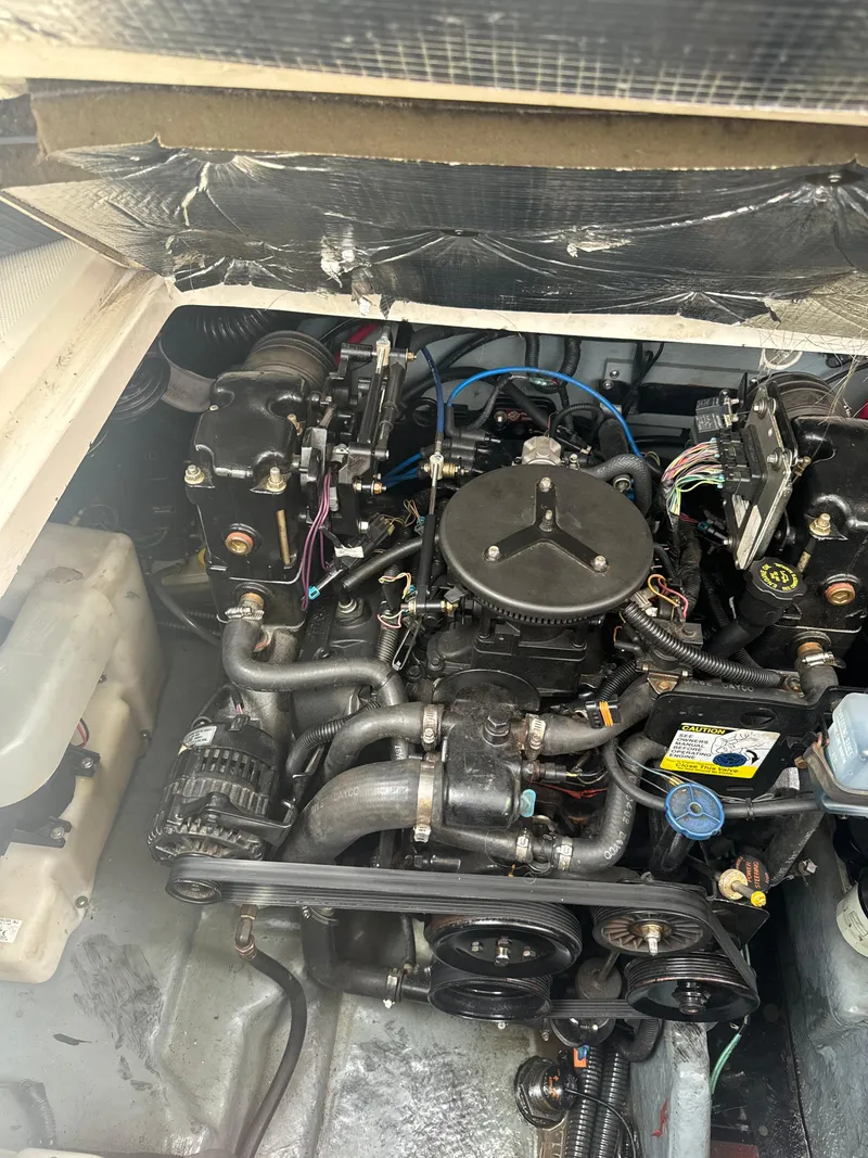 Slide: The Image of Engine compartment of a 2002 Sea Ray Sundancer boat, showcasing mechanical components. - 15