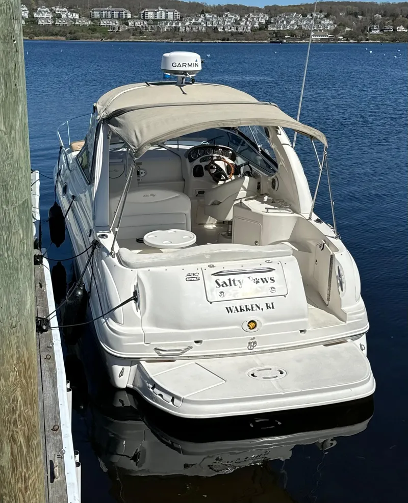 Slide: The Image of 2002 Sea Ray Sundancer boat docked on calm water, featuring Garmin equipment. - 2