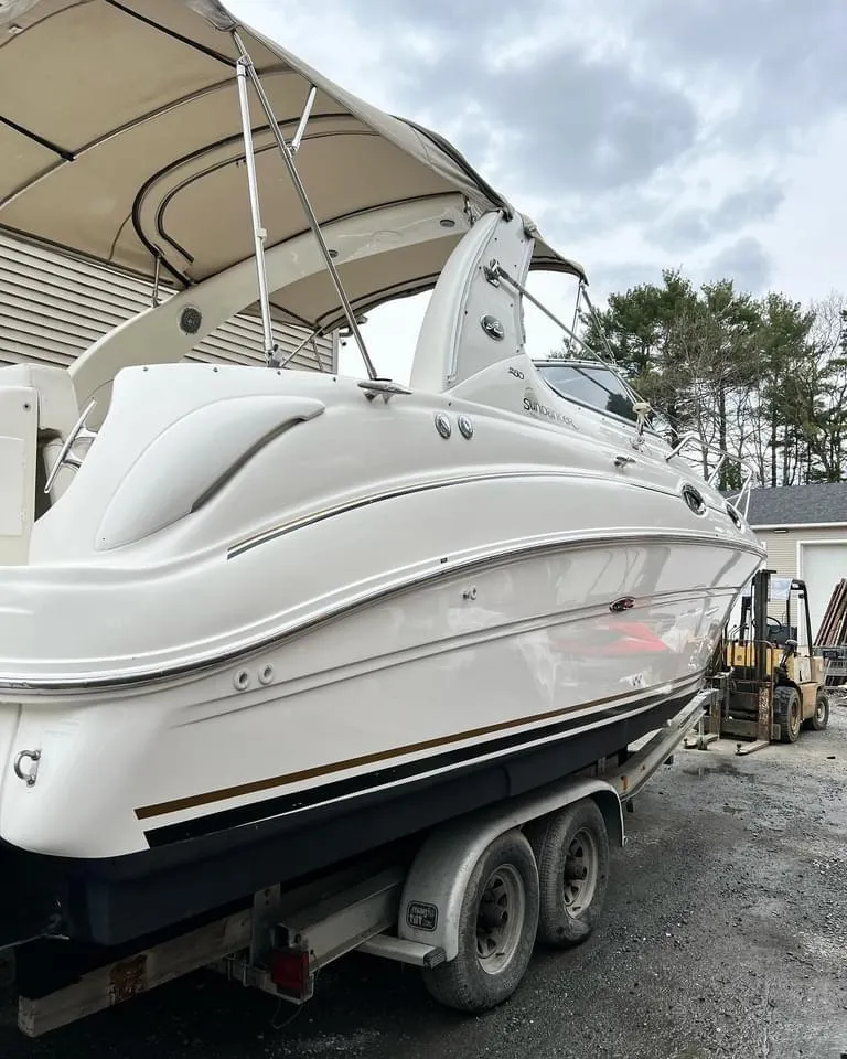 Slide: The Image of 2002 Sea Ray Sundancer boat on trailer, under cloudy sky. - 5