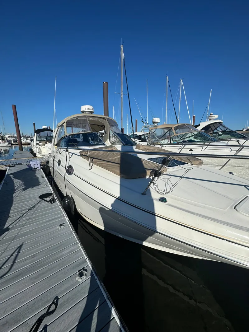 Slide: The Image of 2002 Sea Ray Sundancer yacht docked at marina under clear blue sky. - 6