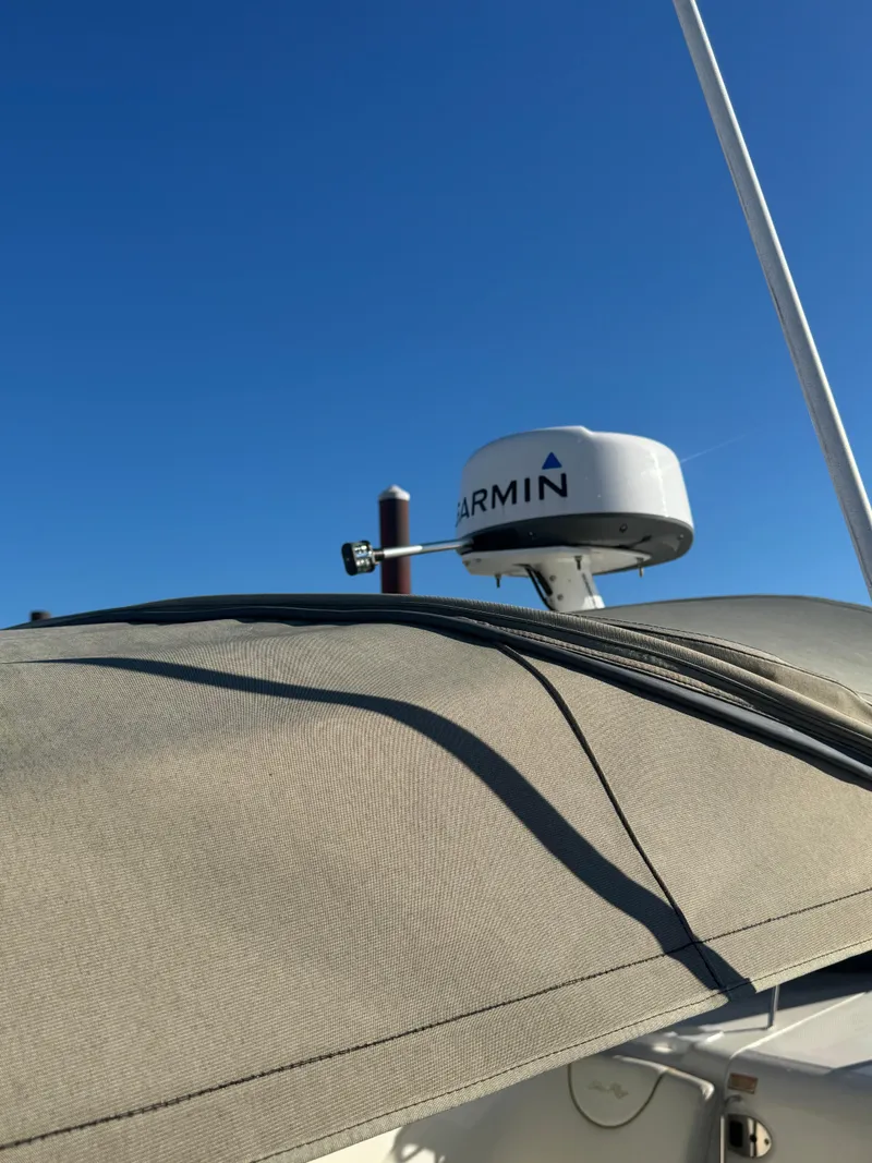 Slide: The Image of 2002 Sea Ray Sundancer with Garmin radar against clear blue sky. - 7