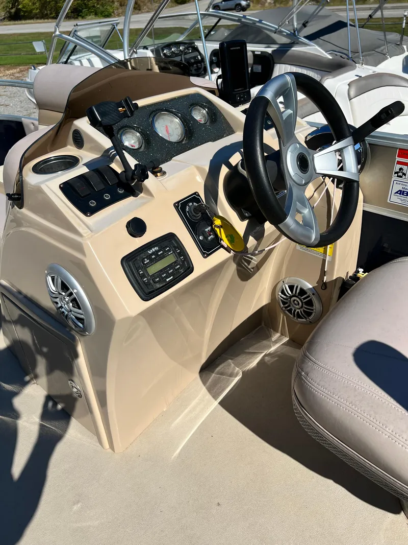 Slide: The Image of 2014 Crest 210FC boat dashboard with steering wheel and control panel. - 4