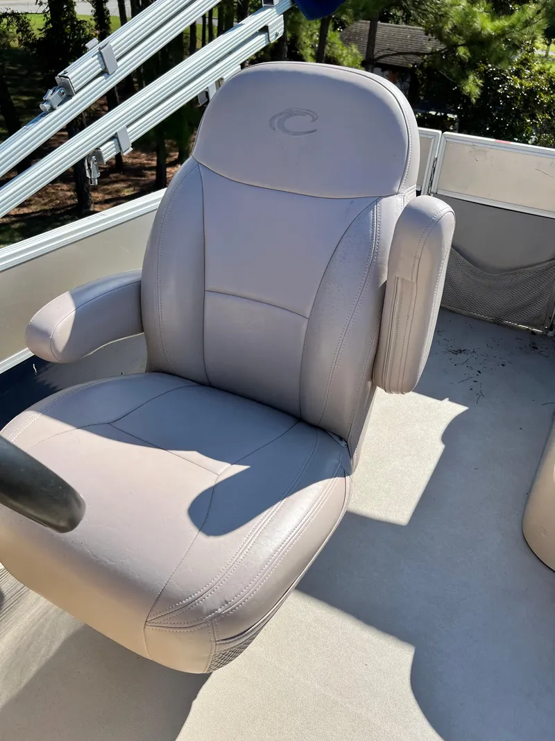 Slide: The Image of Comfortable seating on a 2014 Crest 210FC boat, featuring plush upholstery and armrests. - 5