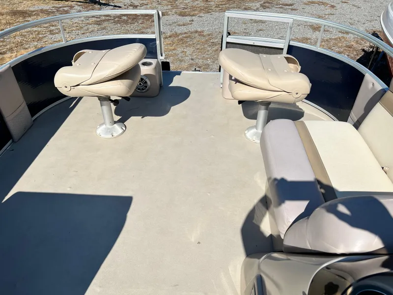 Slide: The Image of 2014 Crest 210FC boat interior with beige seating and open deck space. - 6