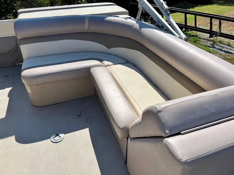 Slide: The Image of 2014 Crest 210FC boat interior with beige and gray cushioned seating. - 7