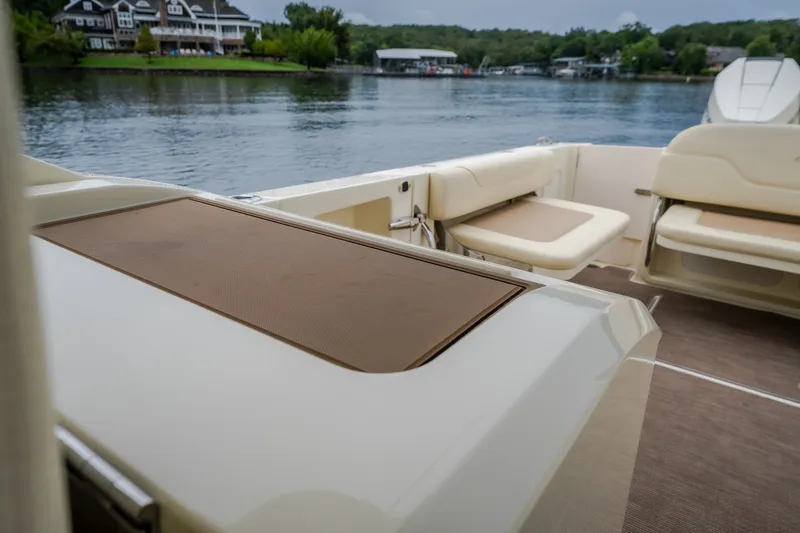 Slide: The Image of 2024 Chris-Craft Calypso 32 boat interior with seating, overlooking a serene waterfront. - 69