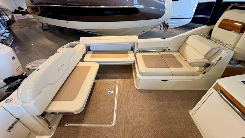 Slide: The Image of 2024 Chris-Craft Calypso 32 CT interior with beige seating and elegant design. - 11