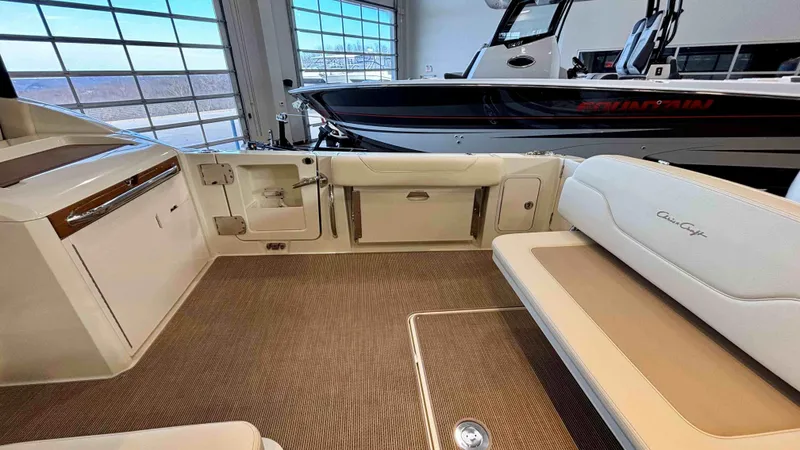 Slide: The Image of 2024 Chris-Craft Calypso 32 CT interior with beige seating and modern design. - 12
