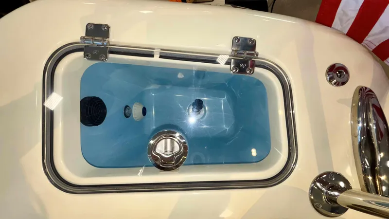 Slide: The Image of 2024 Chris-Craft Calypso 32 CT livewell with blue interior and stainless steel hardware. - 15