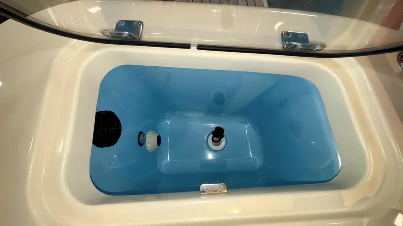 Slide: The Image of 2024 Chris-Craft Calypso 32 CT livewell with blue interior and clear lid. - 16