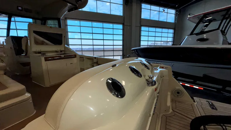 Slide: The Image of 2024 Chris-Craft Calypso 32 CT interior view in a showroom setting. - 17