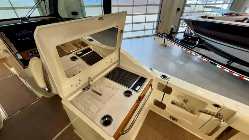 Slide: The Image of 2024 Chris-Craft Calypso 32 CT interior with kitchenette and modern design. - 19