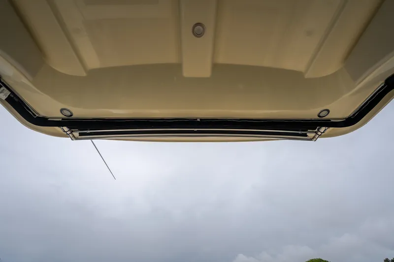 Slide: The Image of 2024 Chris-Craft Calypso 32 boat canopy viewed from below against cloudy sky. - 59