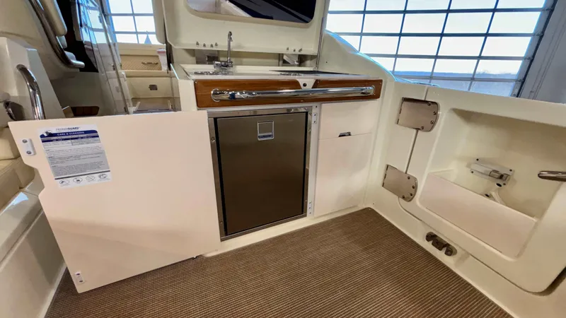 Slide: The Image of 2024 Chris-Craft Calypso 32 CT interior with kitchenette and storage. - 20