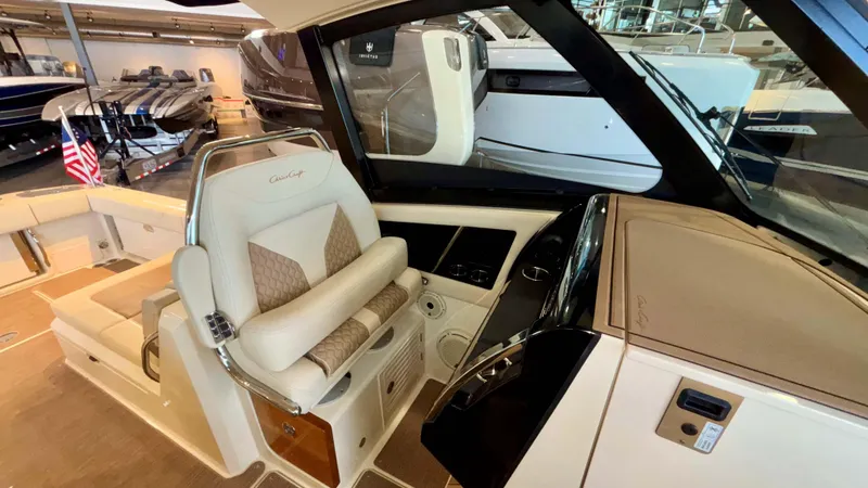 Slide: The Image of 2024 Chris-Craft Calypso 32 CT helm with luxurious seating and modern controls. - 26